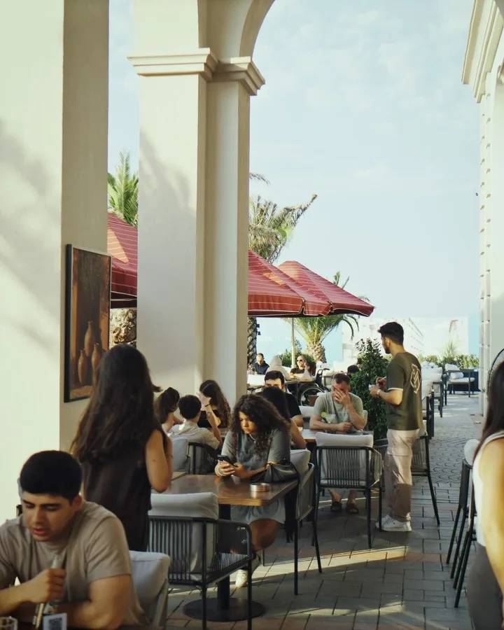 Guests on the terrace by the arcade columns